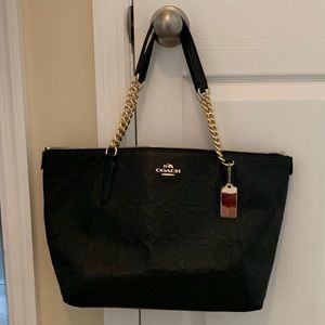 Coach bag with gold accents.